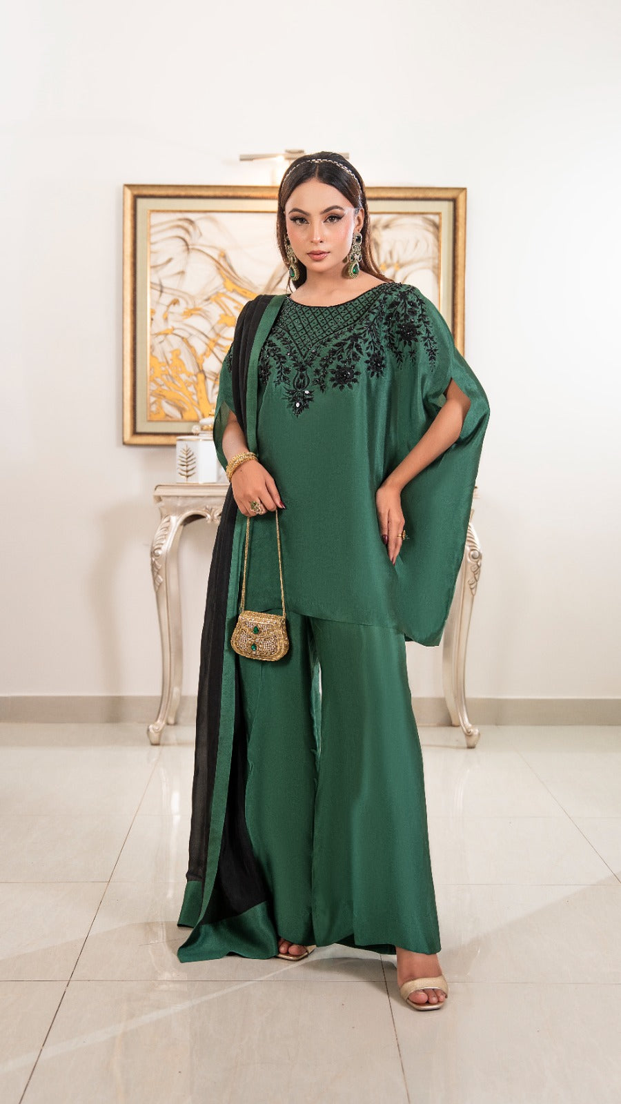 Shop the Royal Emerald Set by FAMA by Sana Sarah's, a breathtaking 3-piece emerald green kaftan tunic with black hand-embroidery, flared silk trousers, and a contrast black dupatta.