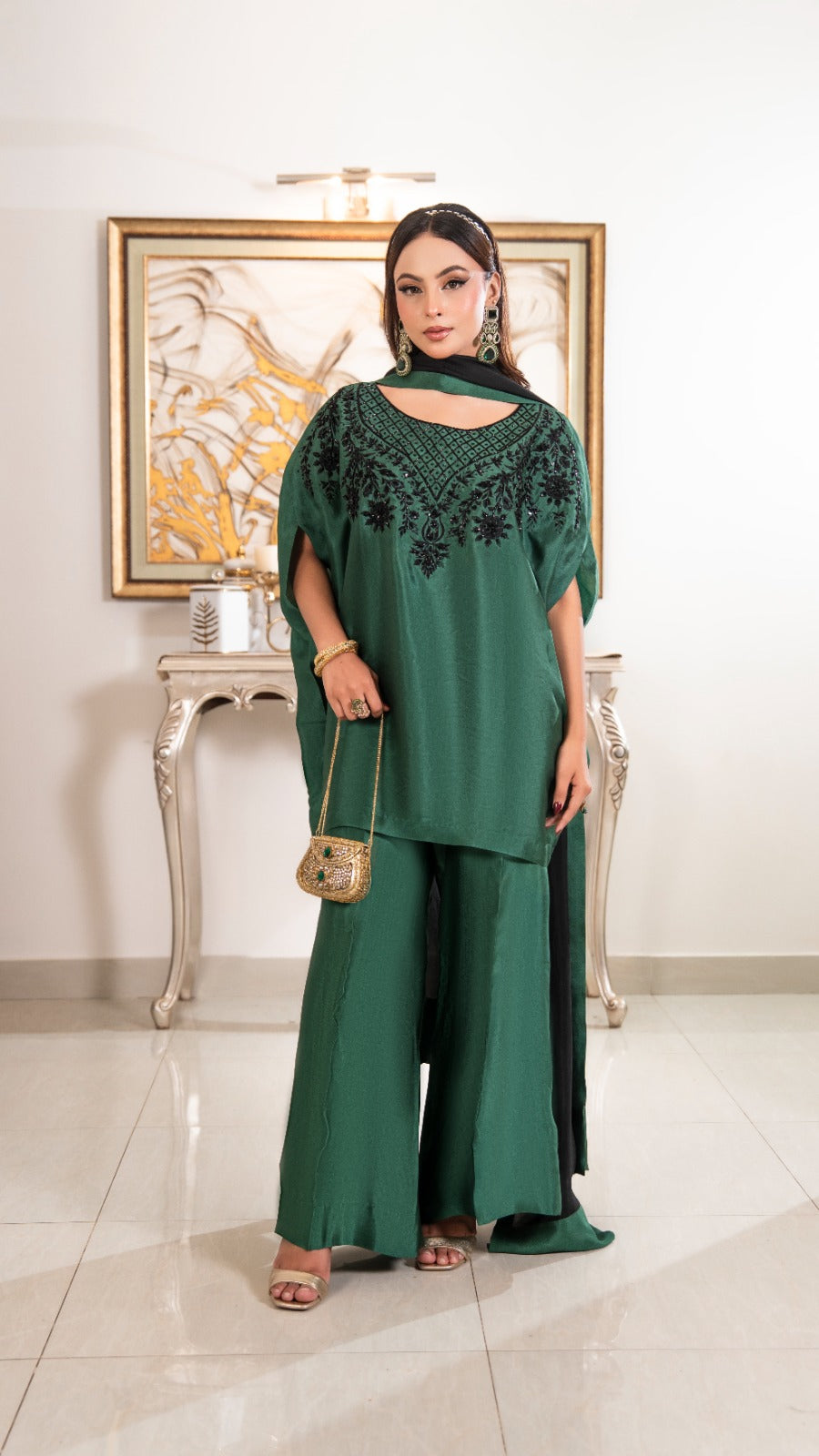 Shop the Royal Emerald Set by FAMA by Sana Sarah's, a breathtaking 3-piece emerald green kaftan tunic with black hand-embroidery, flared silk trousers, and a contrast black dupatta.