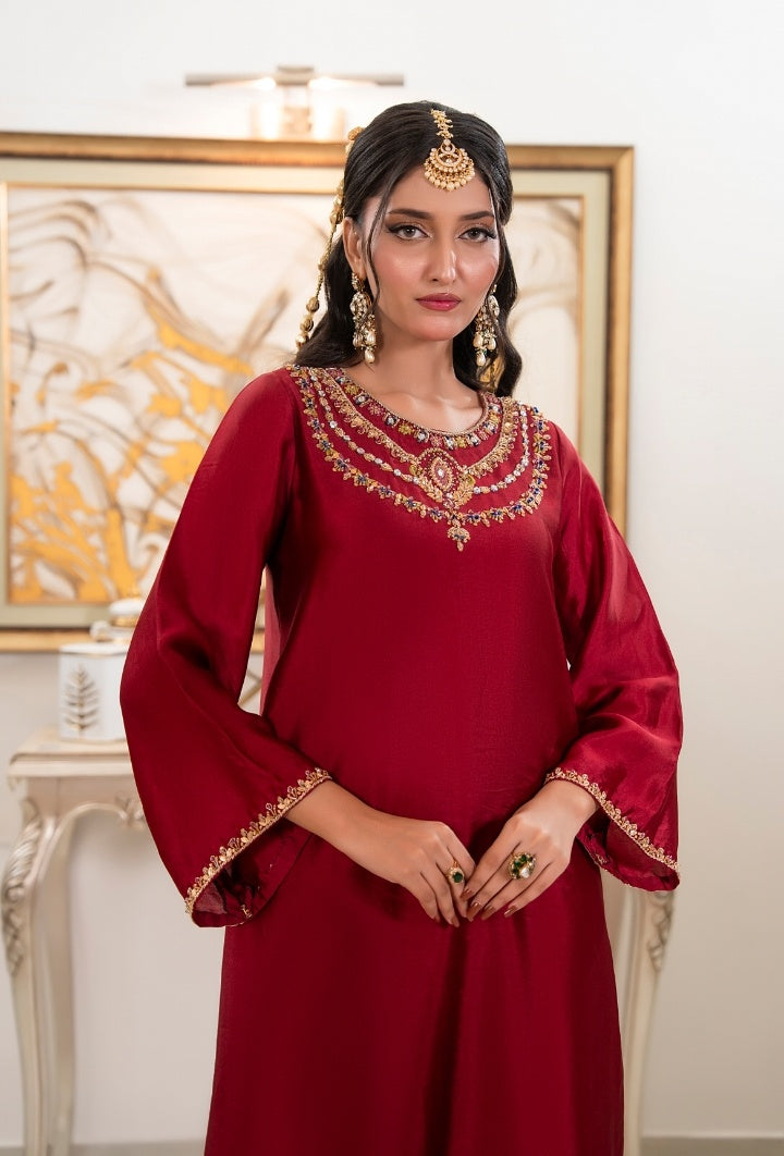 Shop Royal Kaftan by FAMA by Sana Sarah's, a breathtaking deep maroon silk long kaftan featuring a hand-embellished gold and multi-stone jewel collar neckline.