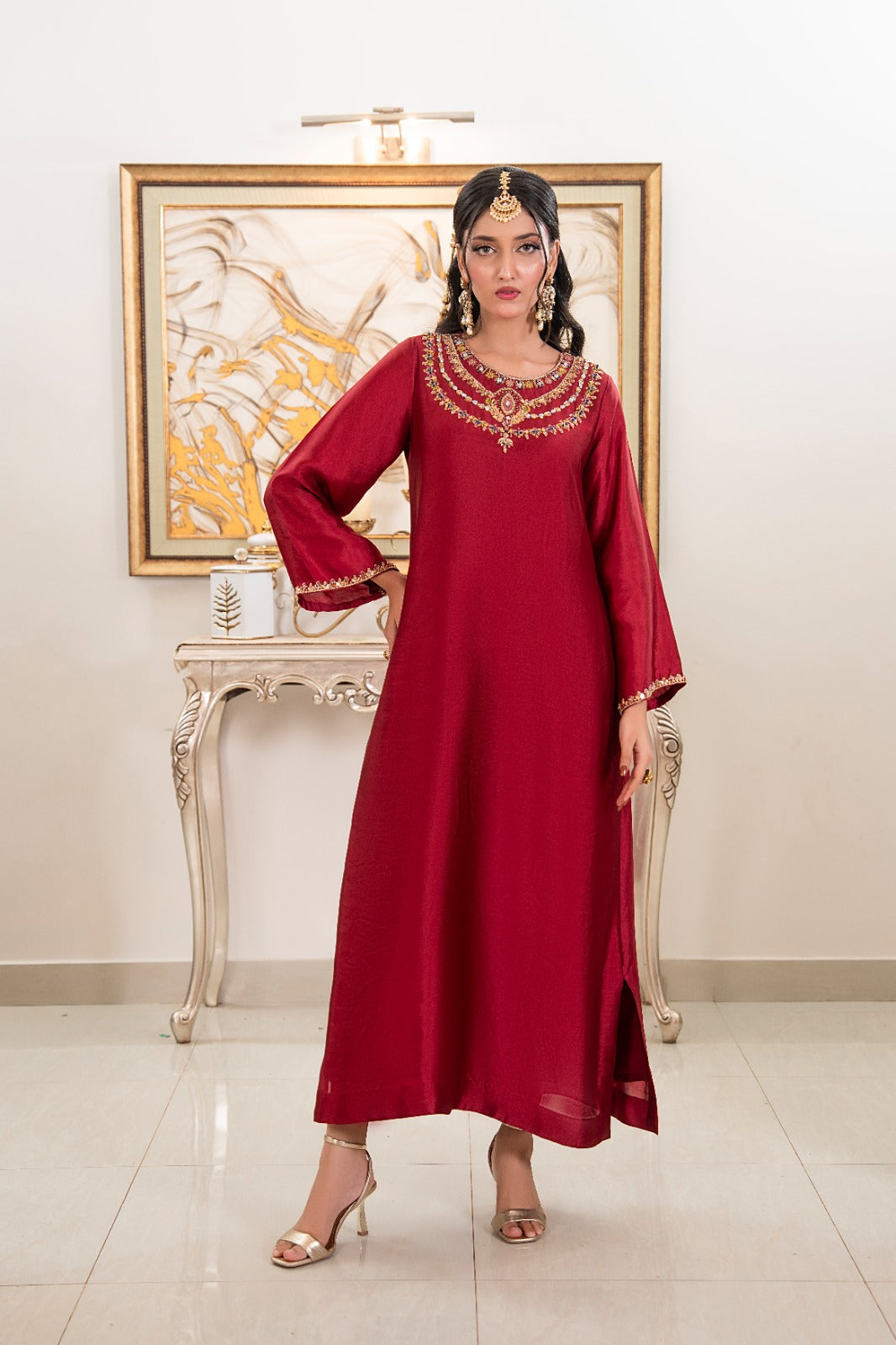 Shop Royal Kaftan by FAMA by Sana Sarah's, a breathtaking deep maroon silk long kaftan featuring a hand-embellished gold and multi-stone jewel collar neckline.
